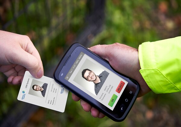 A phone scanning a Johnson Controls' employees' ID card