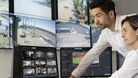 Two colleagues looking at video surveillance footage