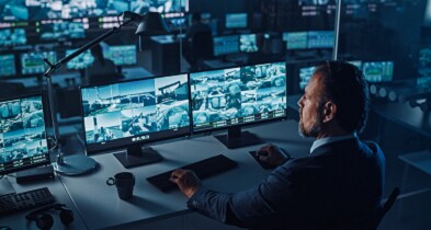 A man watching surveillance videos in a security room
